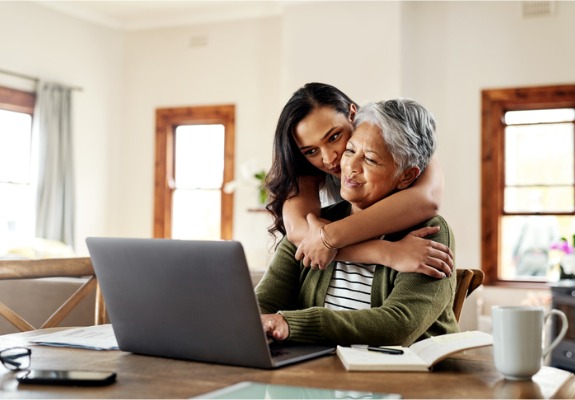 elderly mother and daughter at laptop