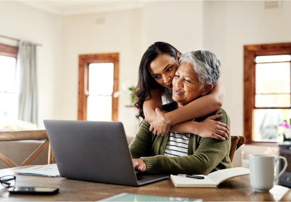 elderly mother and daughter at laptop