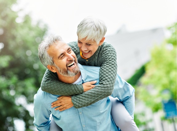 retired couple piggy back